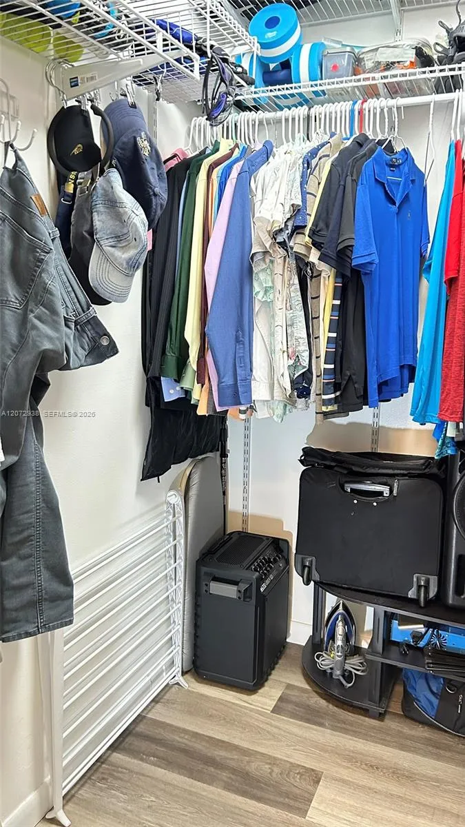 His walk-in closet in primary bedrrom