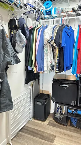 His walk-in closet in primary bedrrom