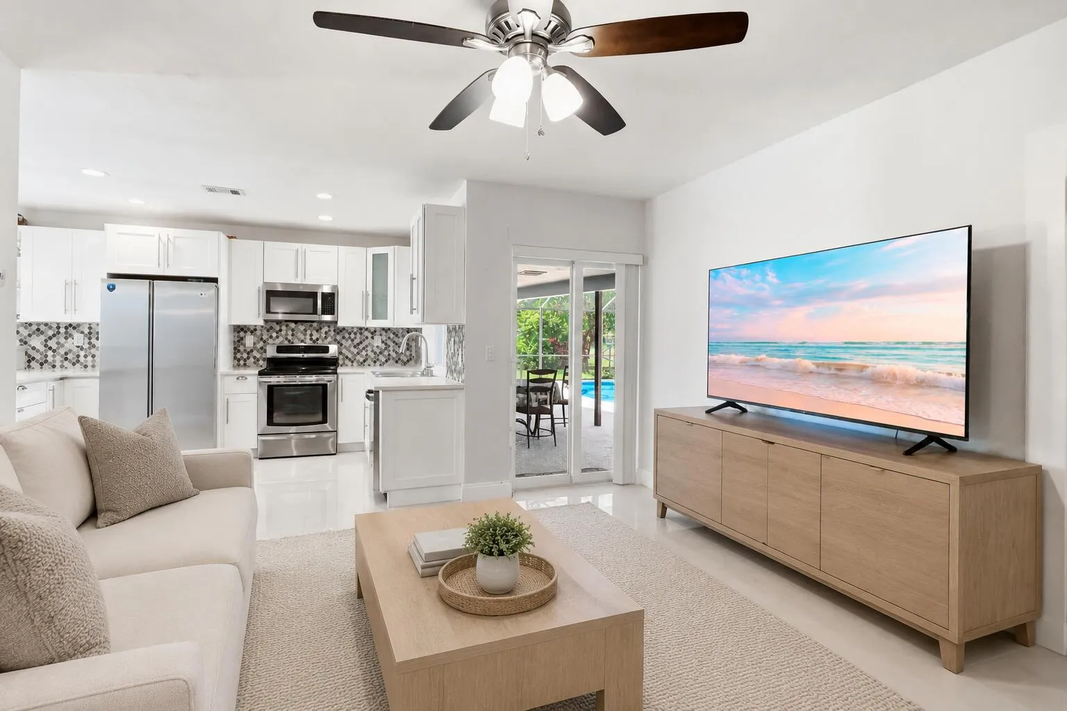 Family Room with access to patio/pool. (virtually staged for illustrative purposes; no permanent features or finishes have been altered)