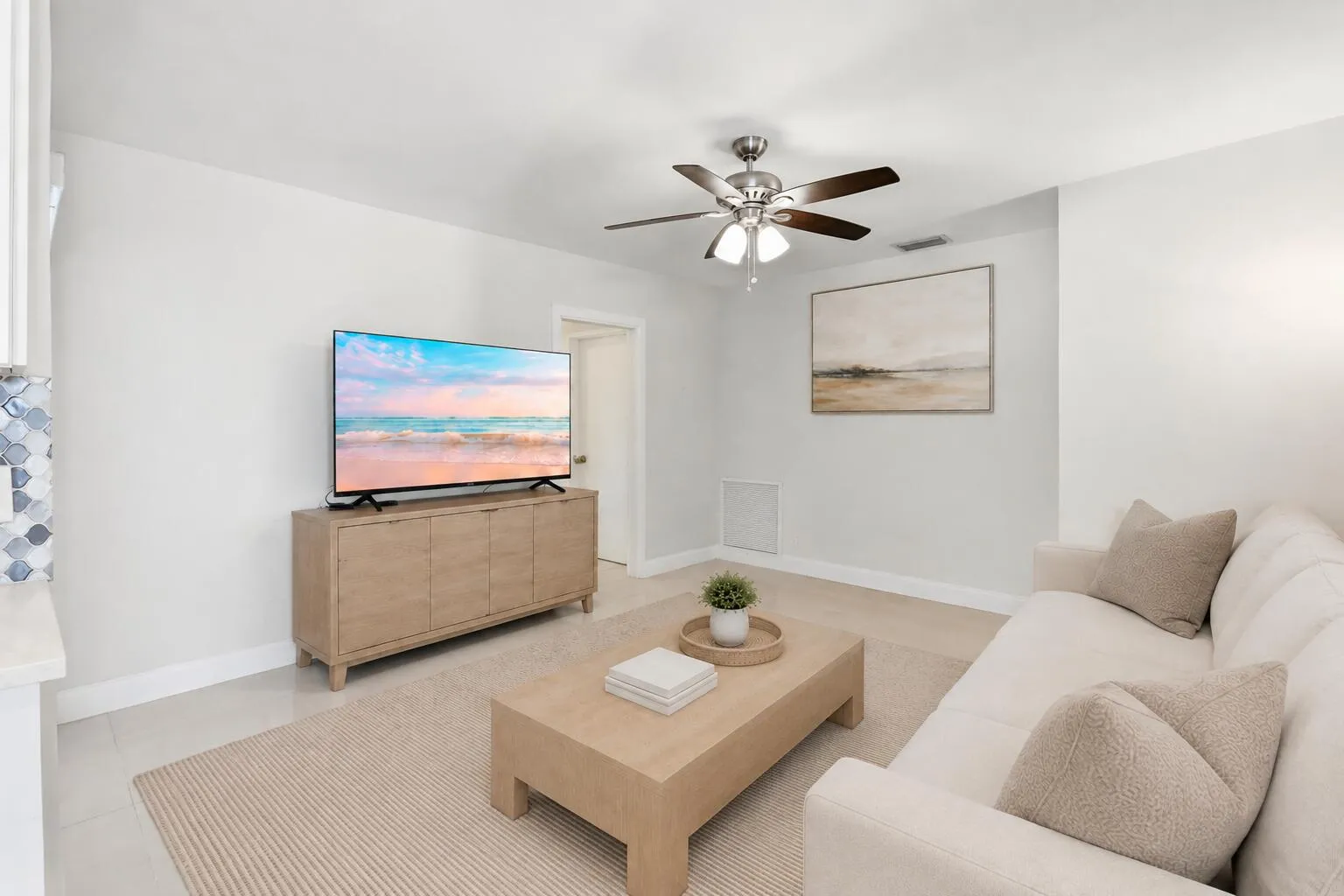 Family Room leads to cabana bath and two bedrooms. (virtually staged for illustrative purposes; no permanent features or finishes have been altered)