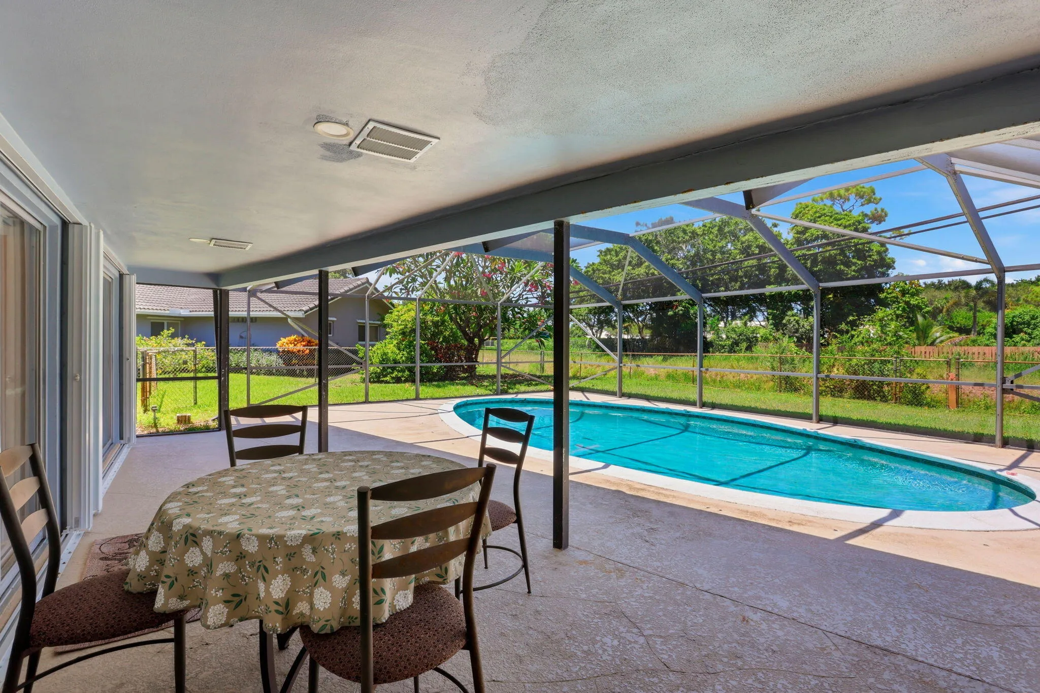 Screen enclosed patio/pool with large overhang.