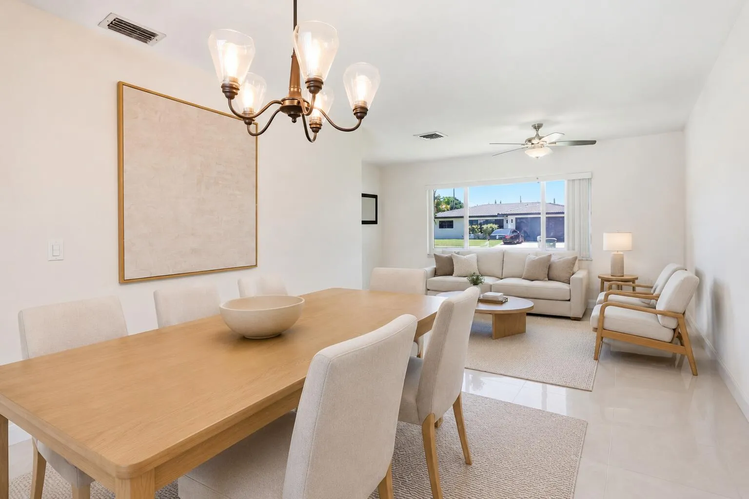Dining Room with view of Living Room. (virtually staged for illustrative purposes; no permanent features or finishes have been altered)