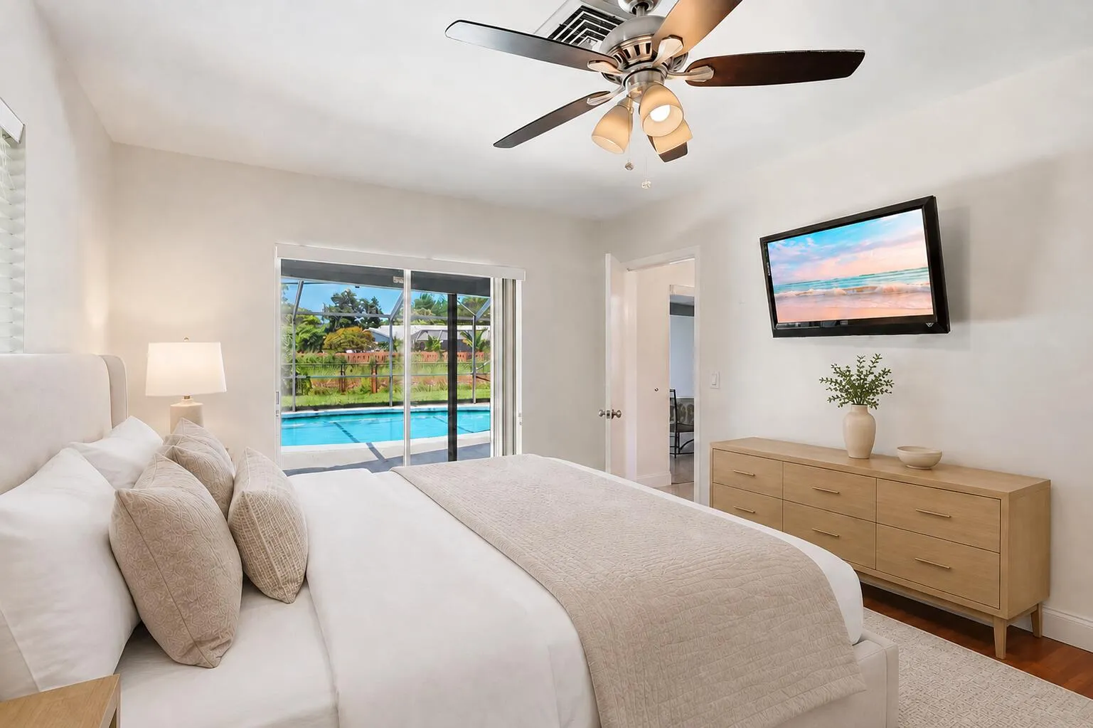 Primary bedroom has direct access to patio/pool. (virtually staged for illustrative purposes; no permanent features or finishes have been altered)
