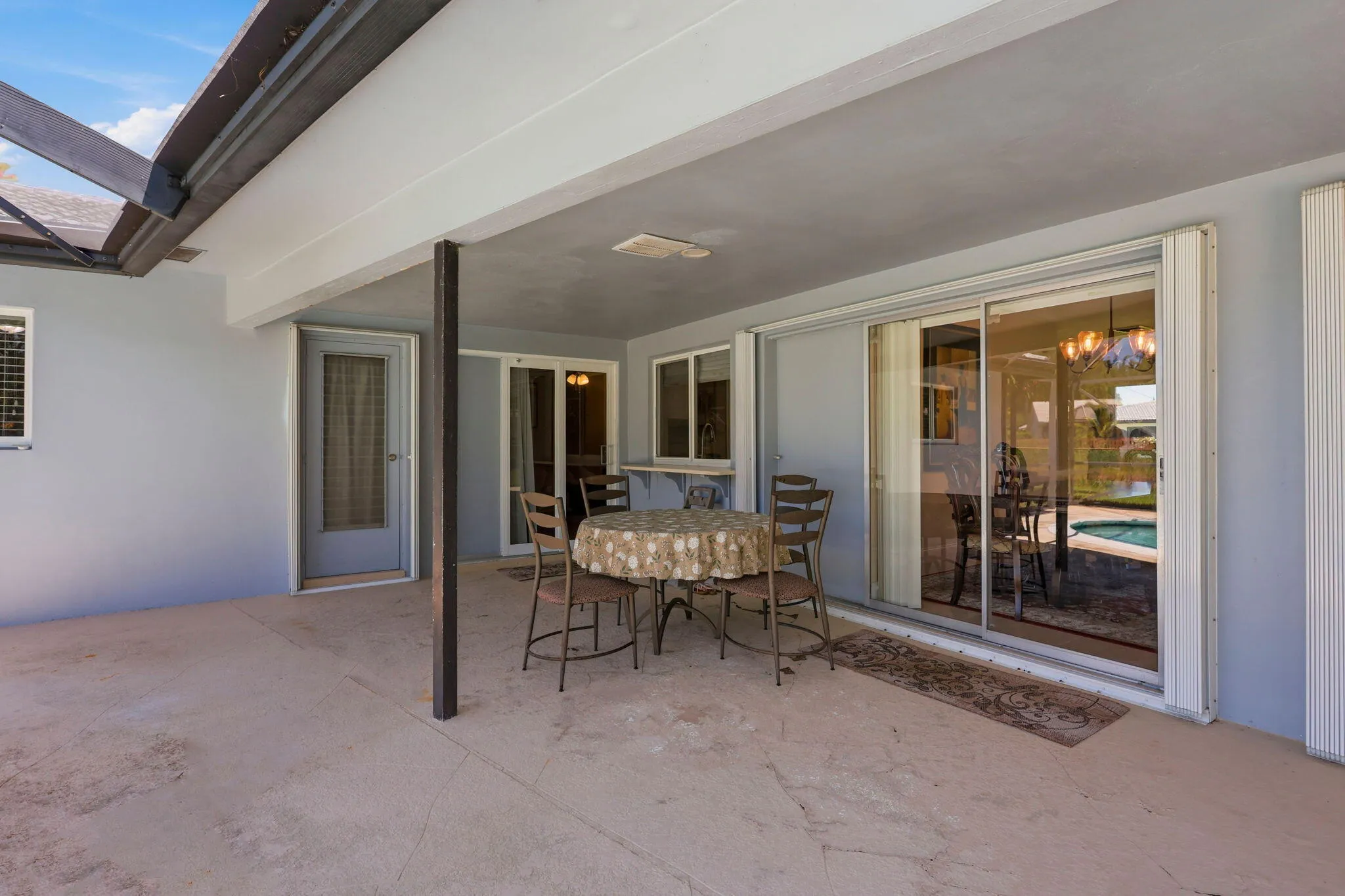 Screen enclosed patio/pool with large overhang.