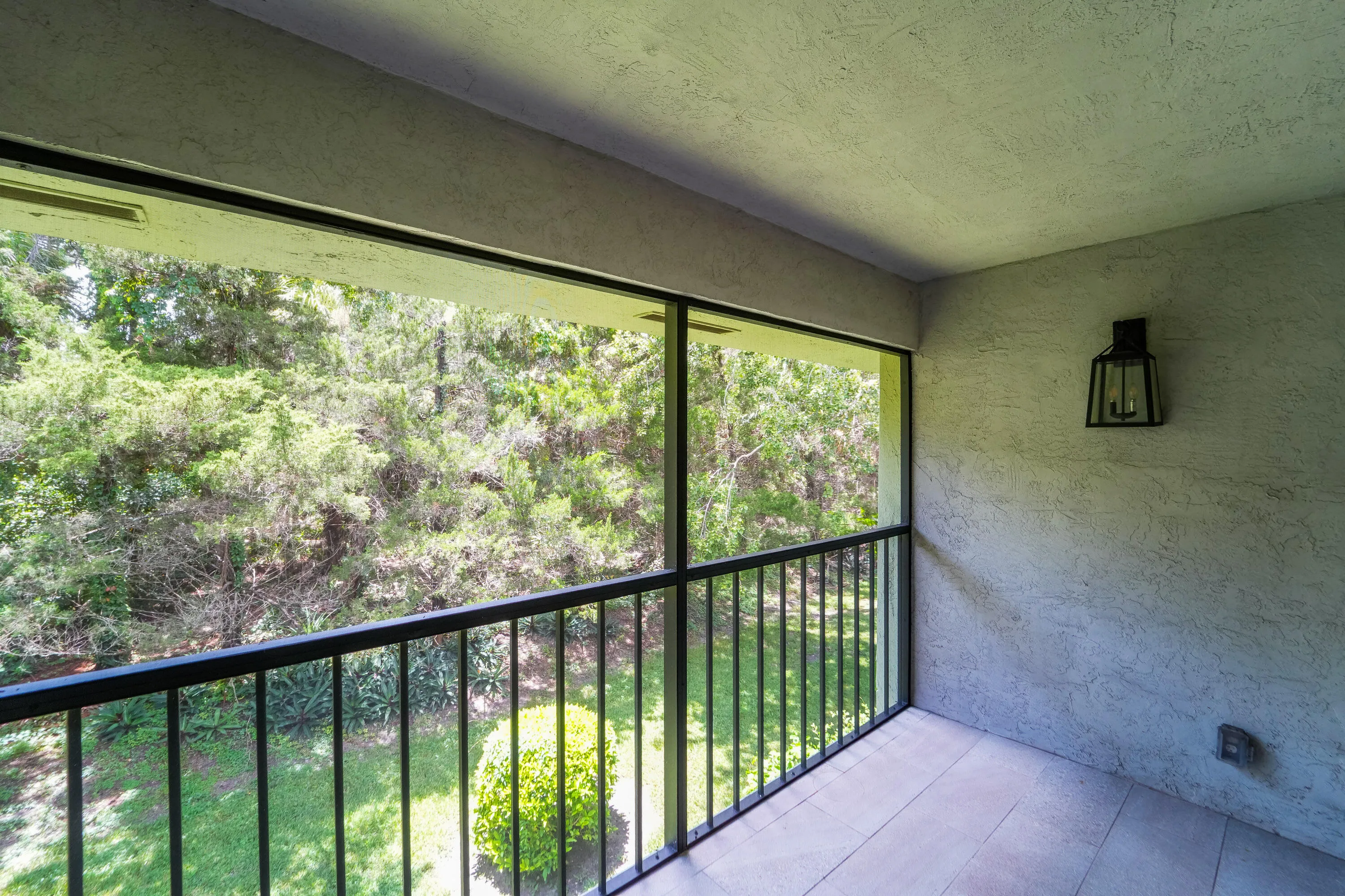 Covered & Screened Back Patio w/ quiet preserve views.
