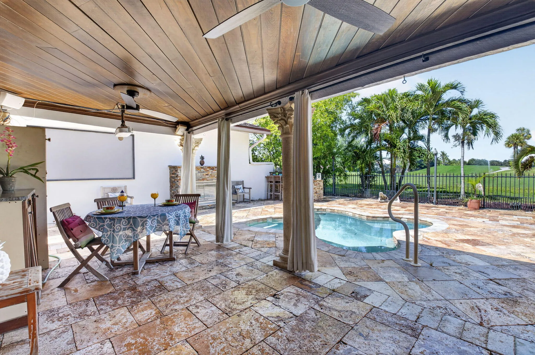 Relax with guests on your oversized travertine paver patio. 20x11' covered patio with beadboard ceiling.