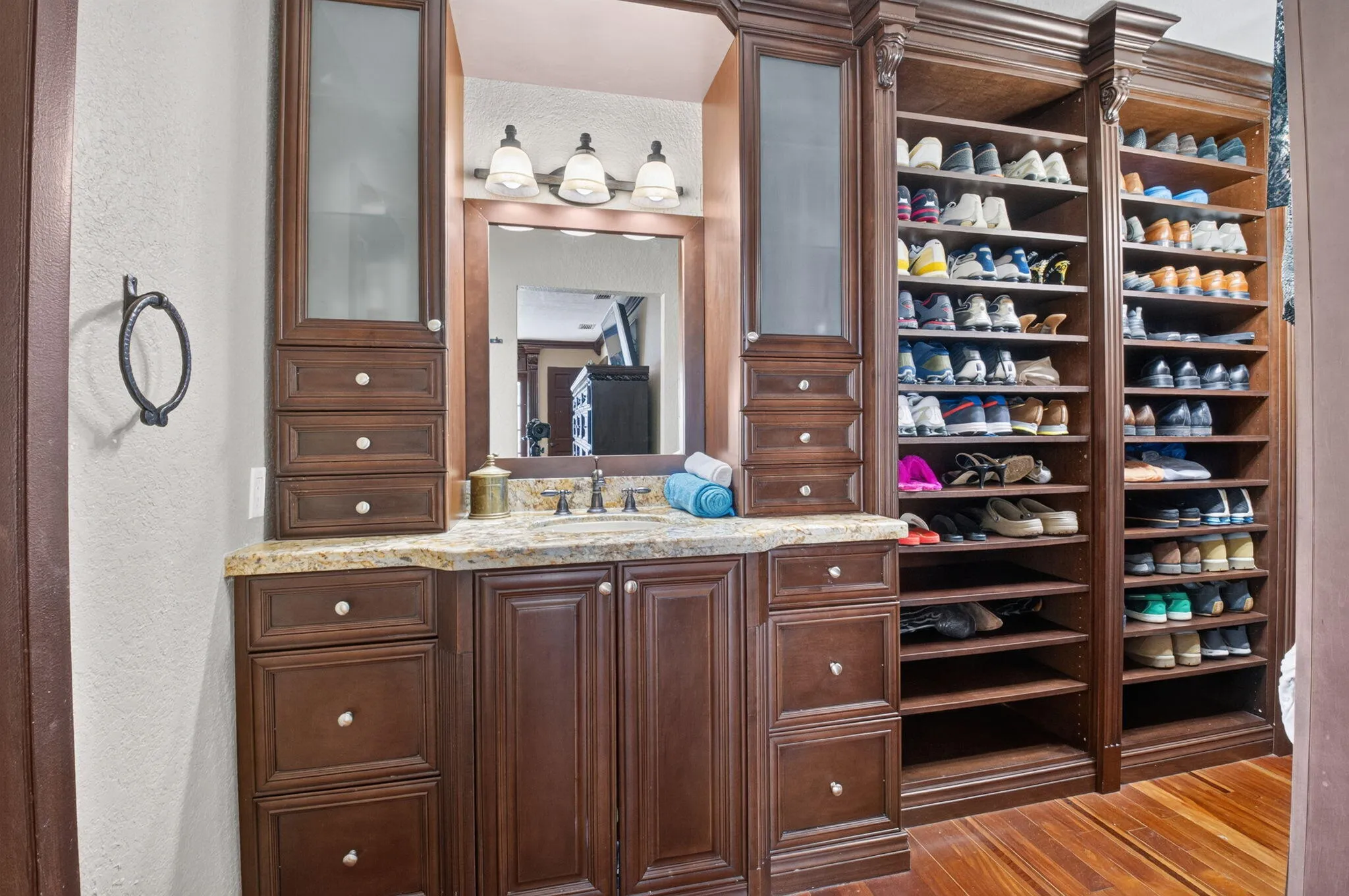 Primary vanity has a counter height vanity, granite counter and undermount sink. Extra cabinets too.