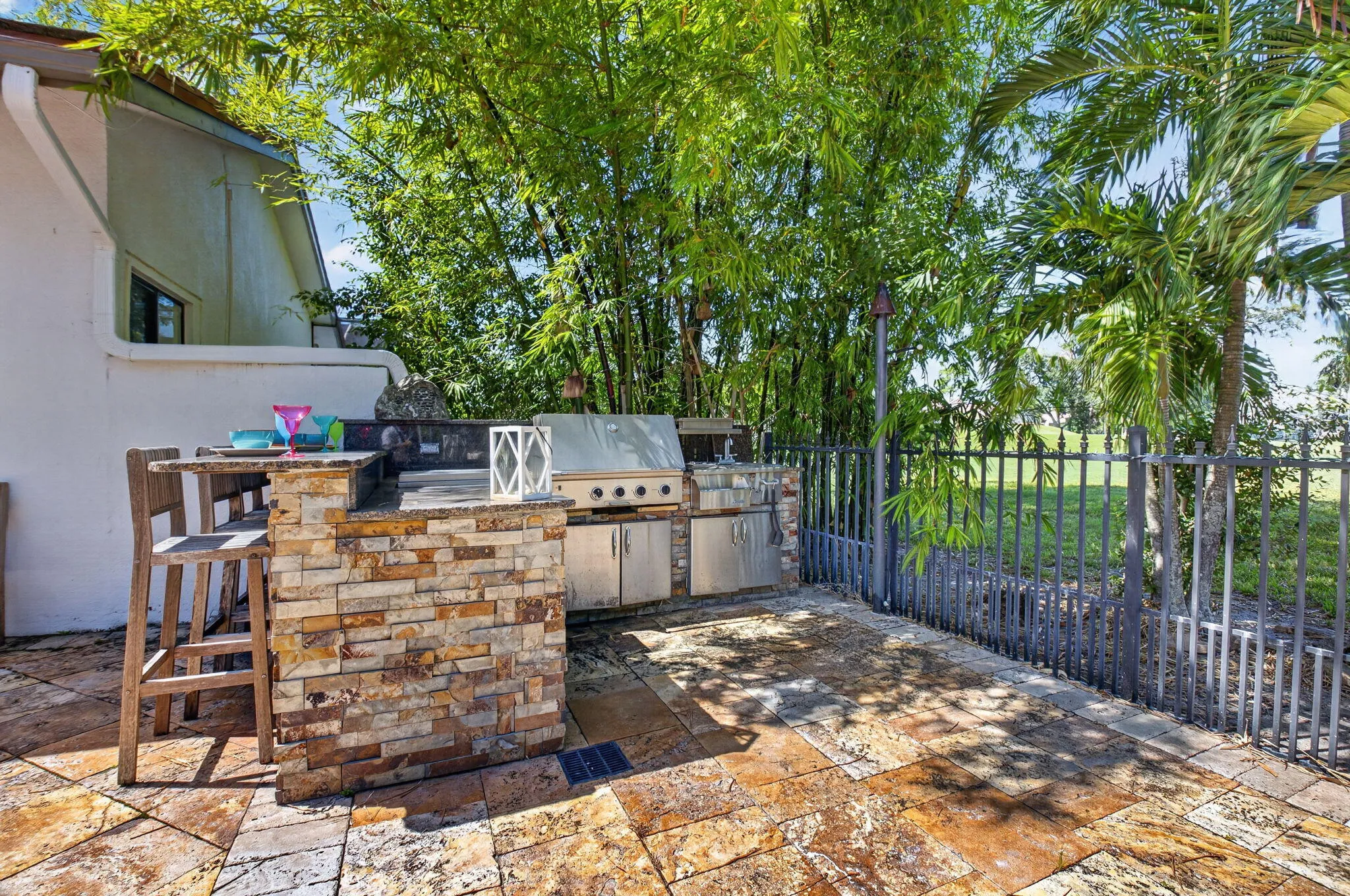 Grill out your burgers at the summer kitchen with wet bar and refrigerator.