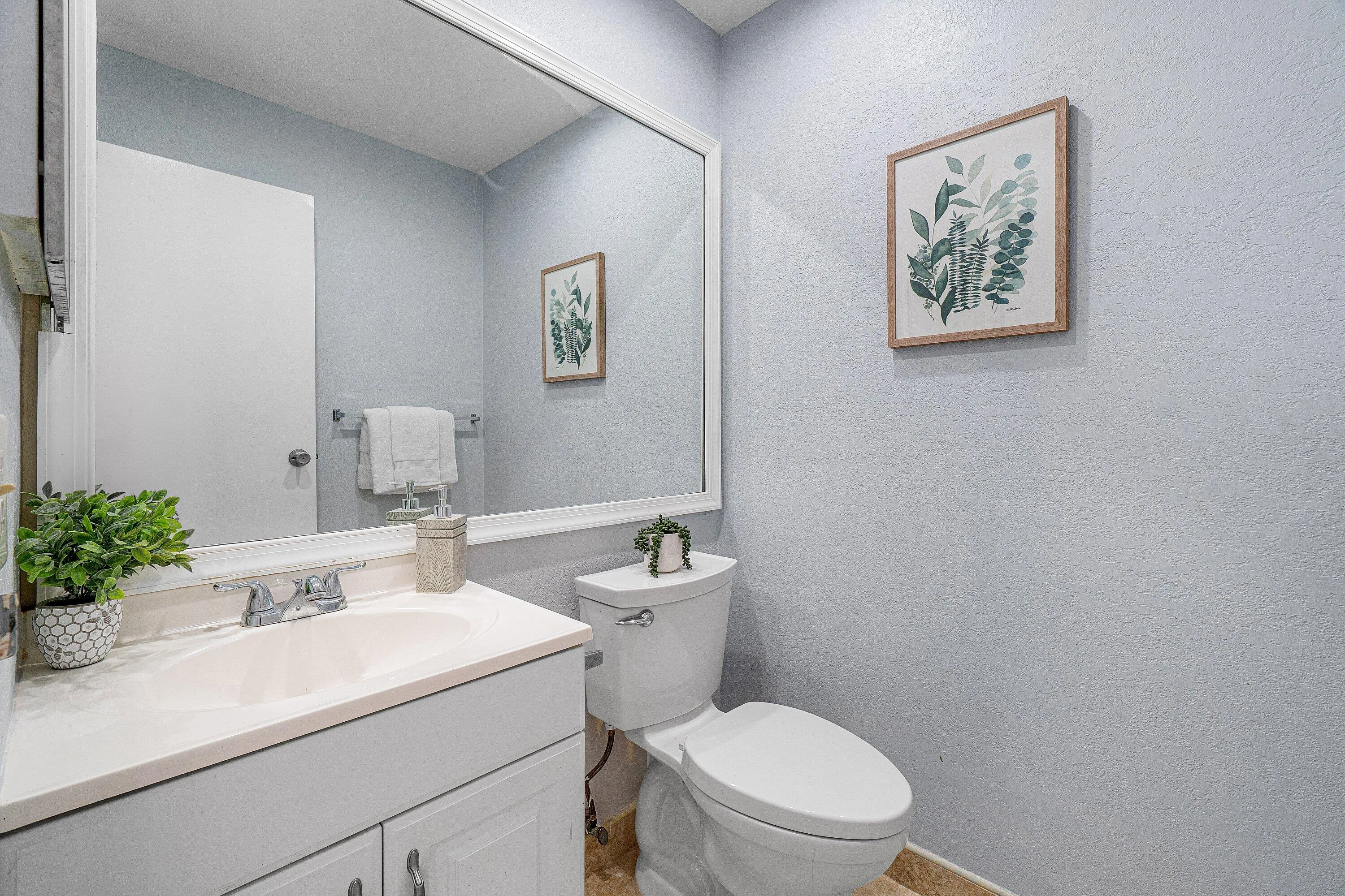 Vanity with an integrated sink, polished chrome faucet, and white cabinetry
