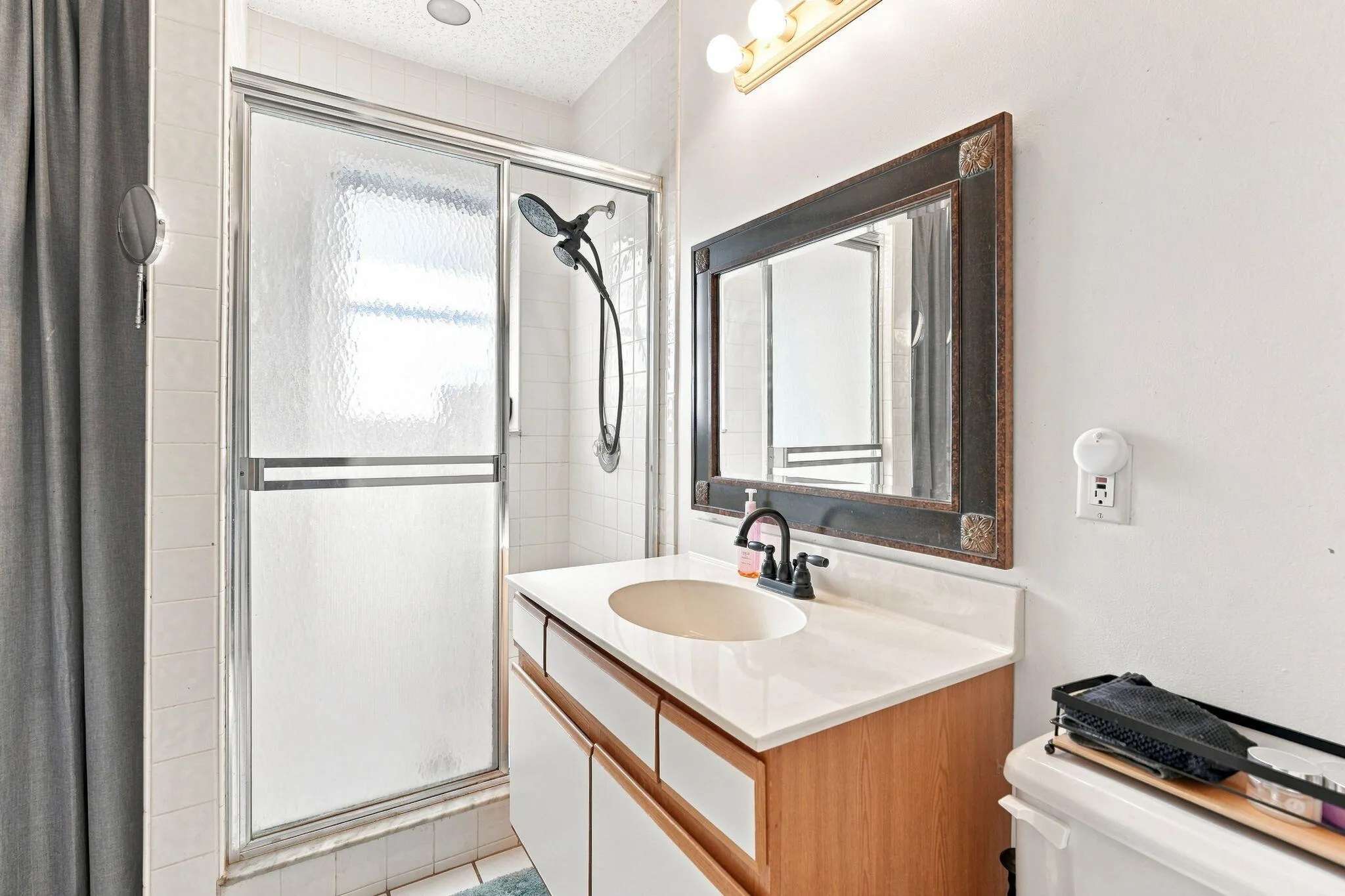 Walk-in shower with textured glass enclosure