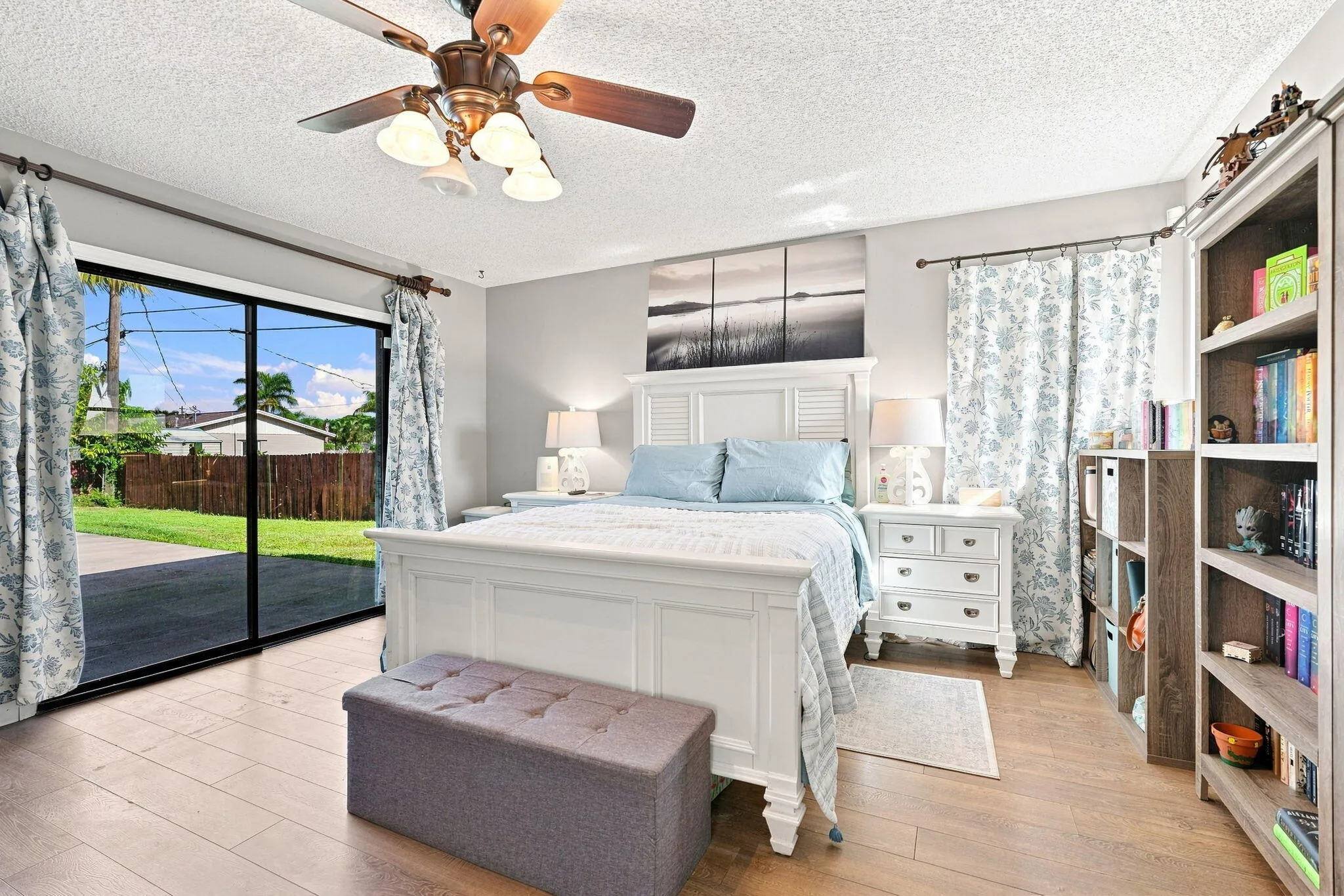 LVP flooring, sliding glass doors and a ceiling fan with integrated lighting