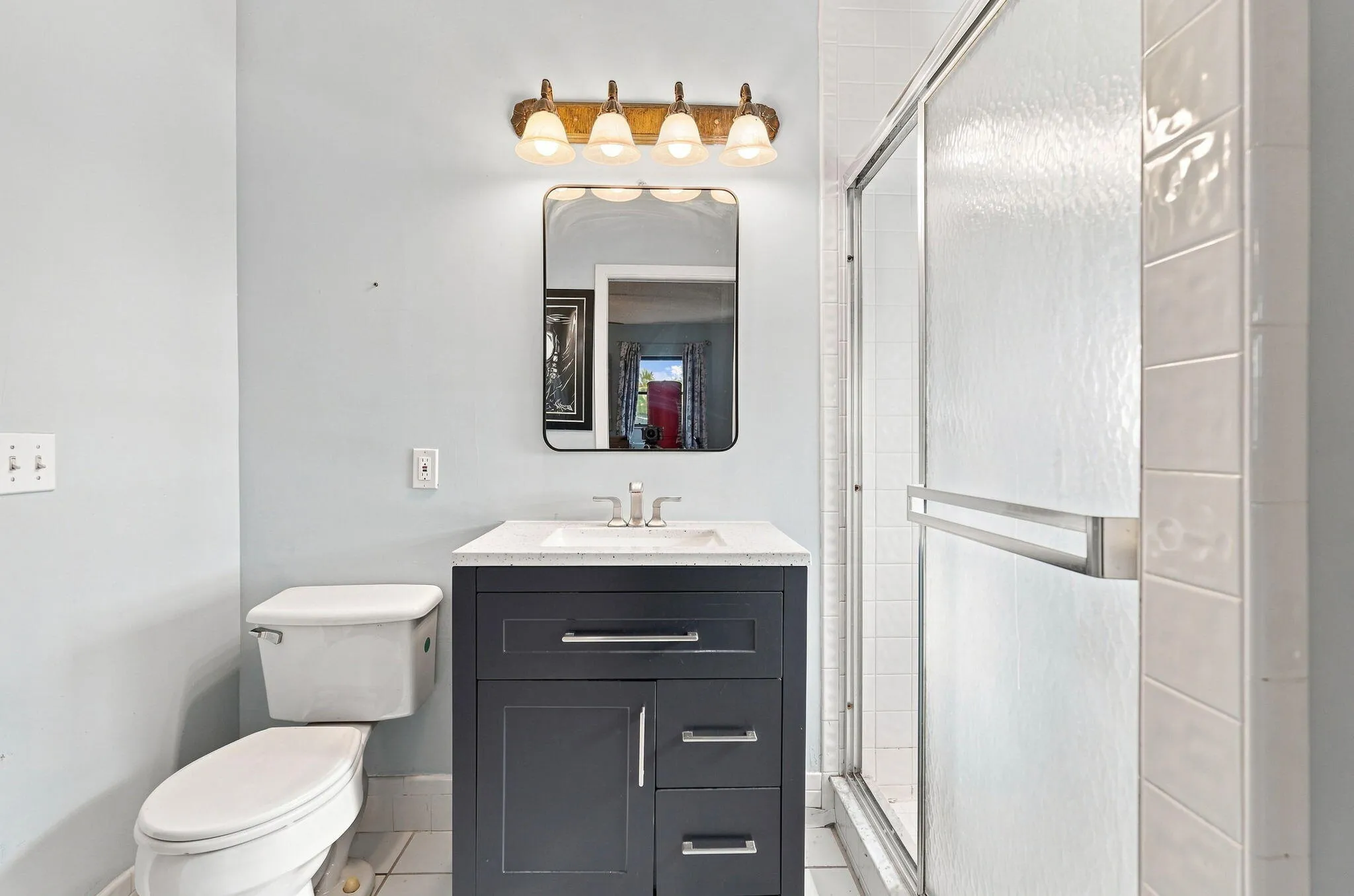 Modern vanity with white countertop, recessed sink and polished chrome faucet