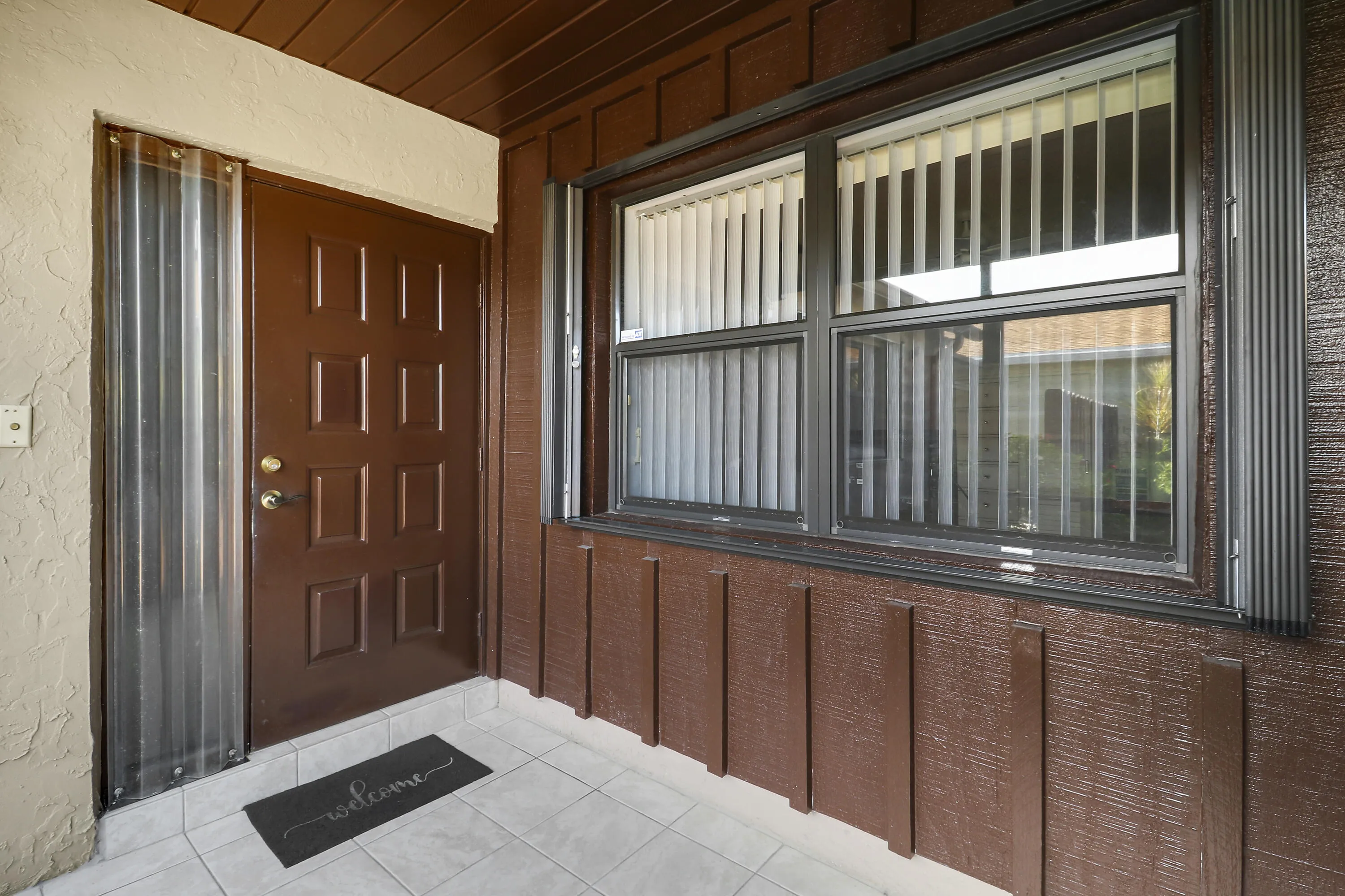 Enter the home or the garage from this covered and screened in space.