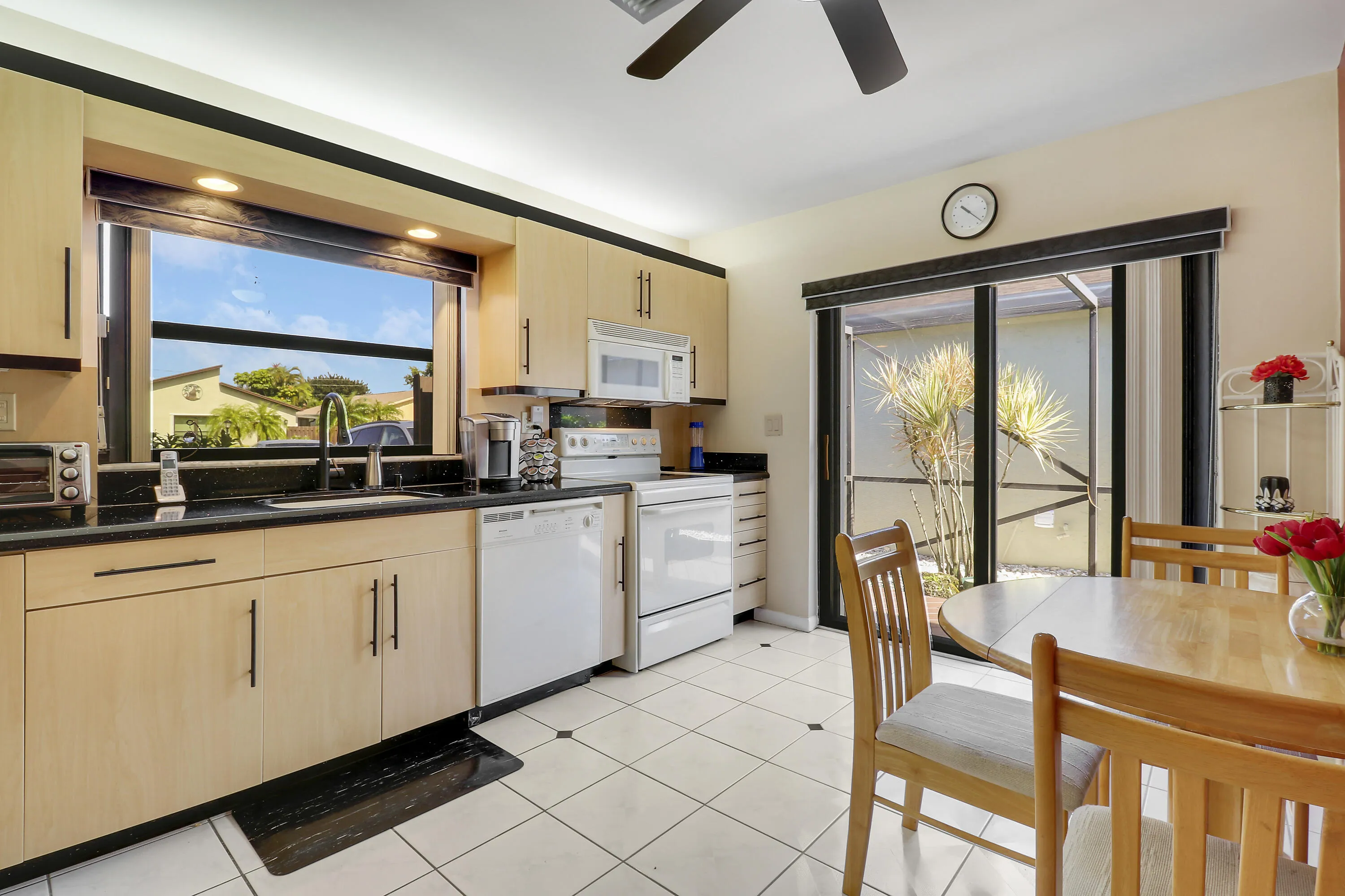 The window and sliding glass doors make the kitchen bright and cheery.
