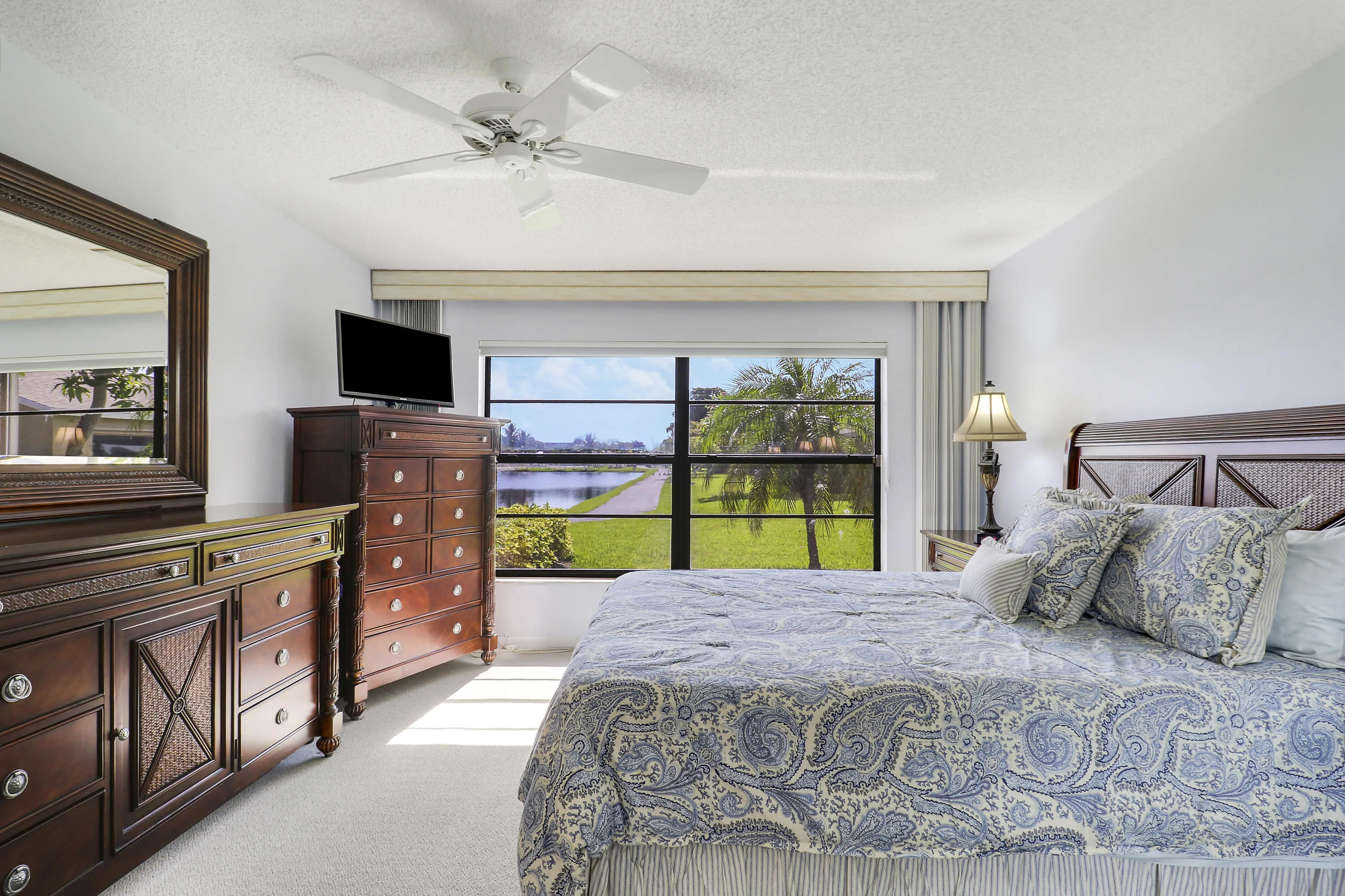 The generous master bedroom offers peaceful lake views.