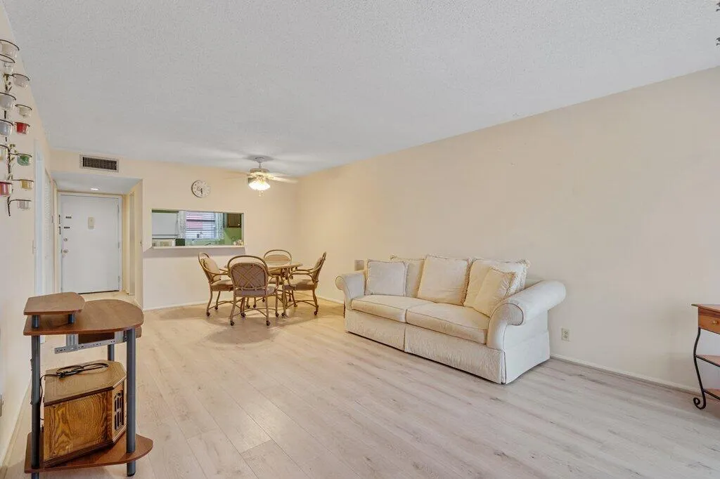 Living area with light-toned walls and wood-finish LVP flooring