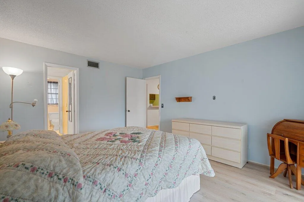 Light-toned wood-finish flooring complements the pastel wall color, enhancing the bright atmosphere