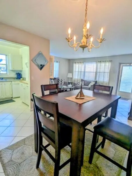 Recessed kitchen with white cabinetry and tile flooring