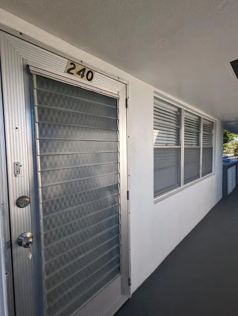 Entry door with louvered glass panels