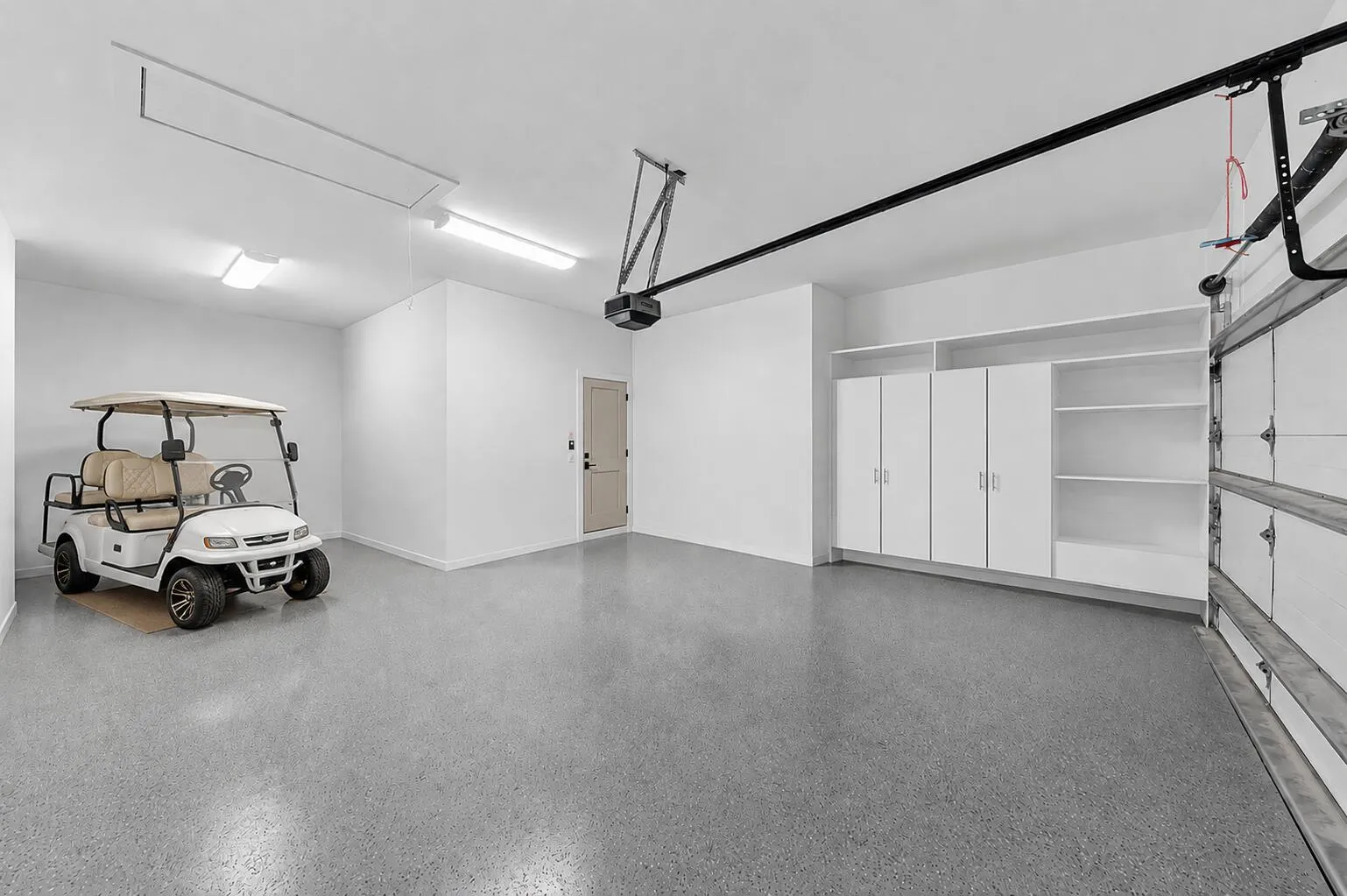 2 car garage with golf cart parking and storage | Virtually Staged