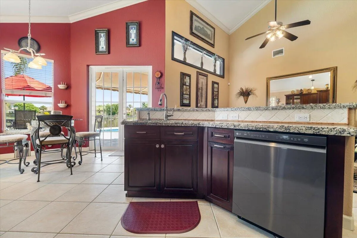 Facing the kitchen Island into the family room, Top of the line hardware features on the sink and faucets throughout, Real Wooden cabinets with soft close doors, Spectacular granite countercops,