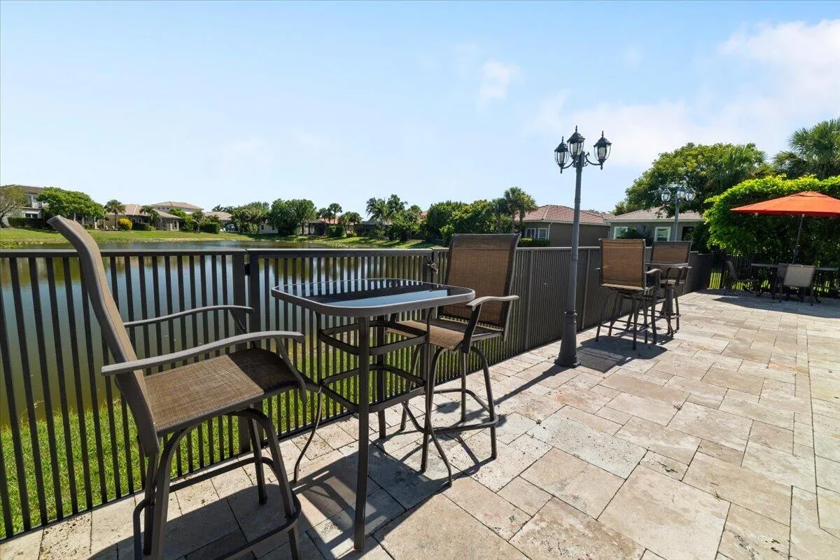 Hightop tables with installed cobblestone streetlights surround the LED multi colored pool,
