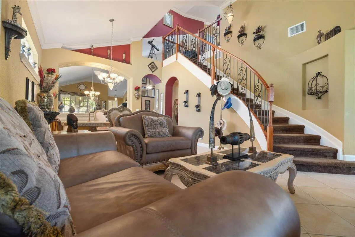 The front living room is large and has a custom wrought iron staircase railing & varnished banister built with solid wood varnish, Italian tile throughout, Leather couches and high end immaculate furniture included, Interior recently painted,