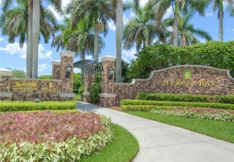 The entryway to one of the 3 guard gated strictly secured gates in Heron Bay, Parkland Florida