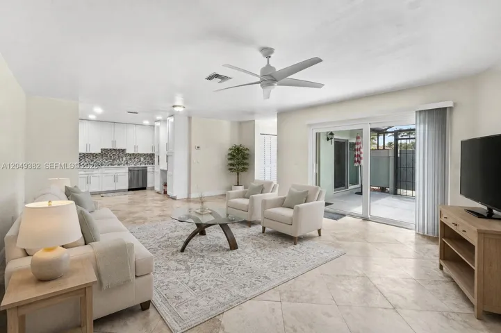 Living area opens to a screened patio with peaceful views