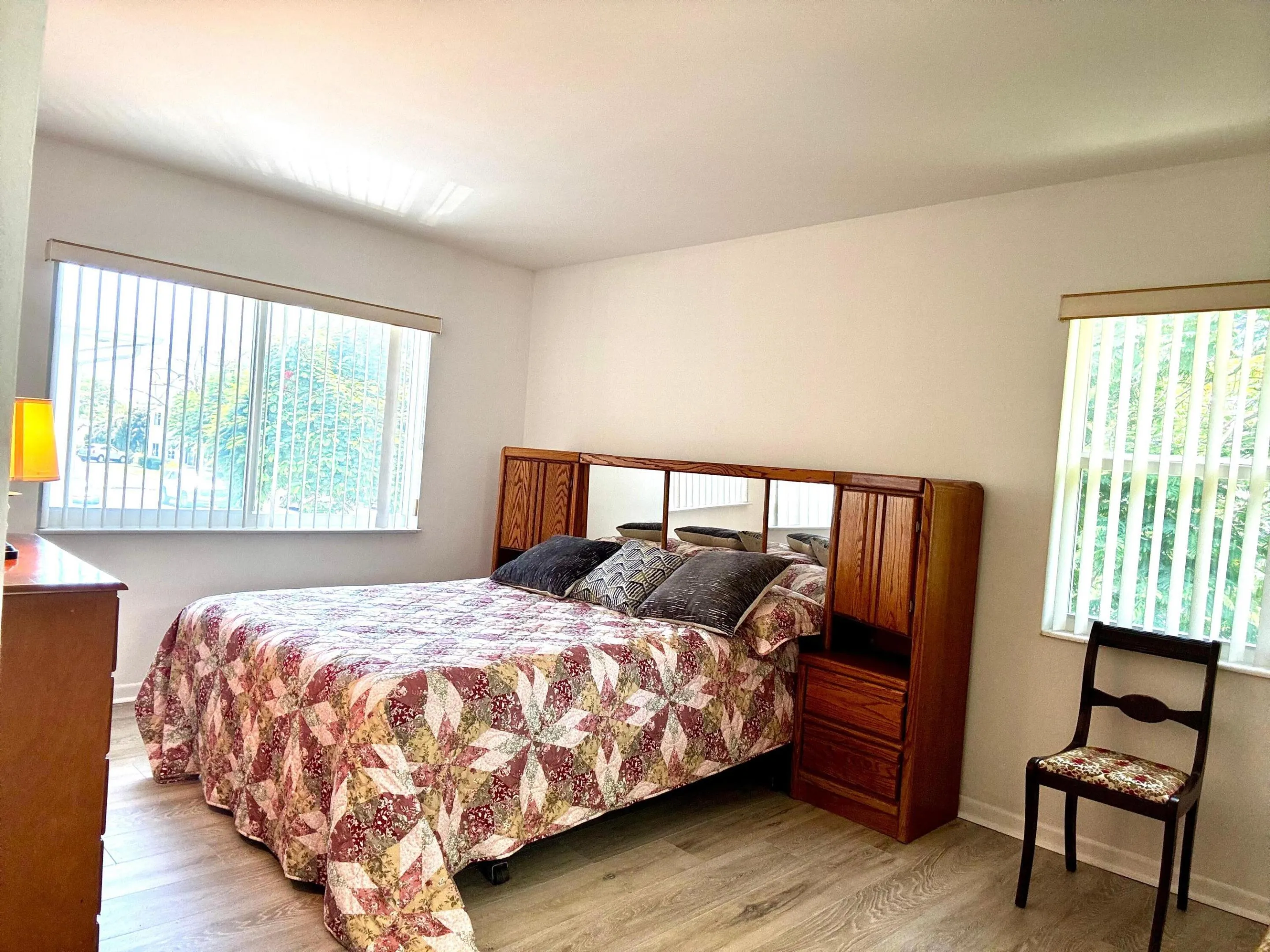 Light wood-finish flooring with white baseboards