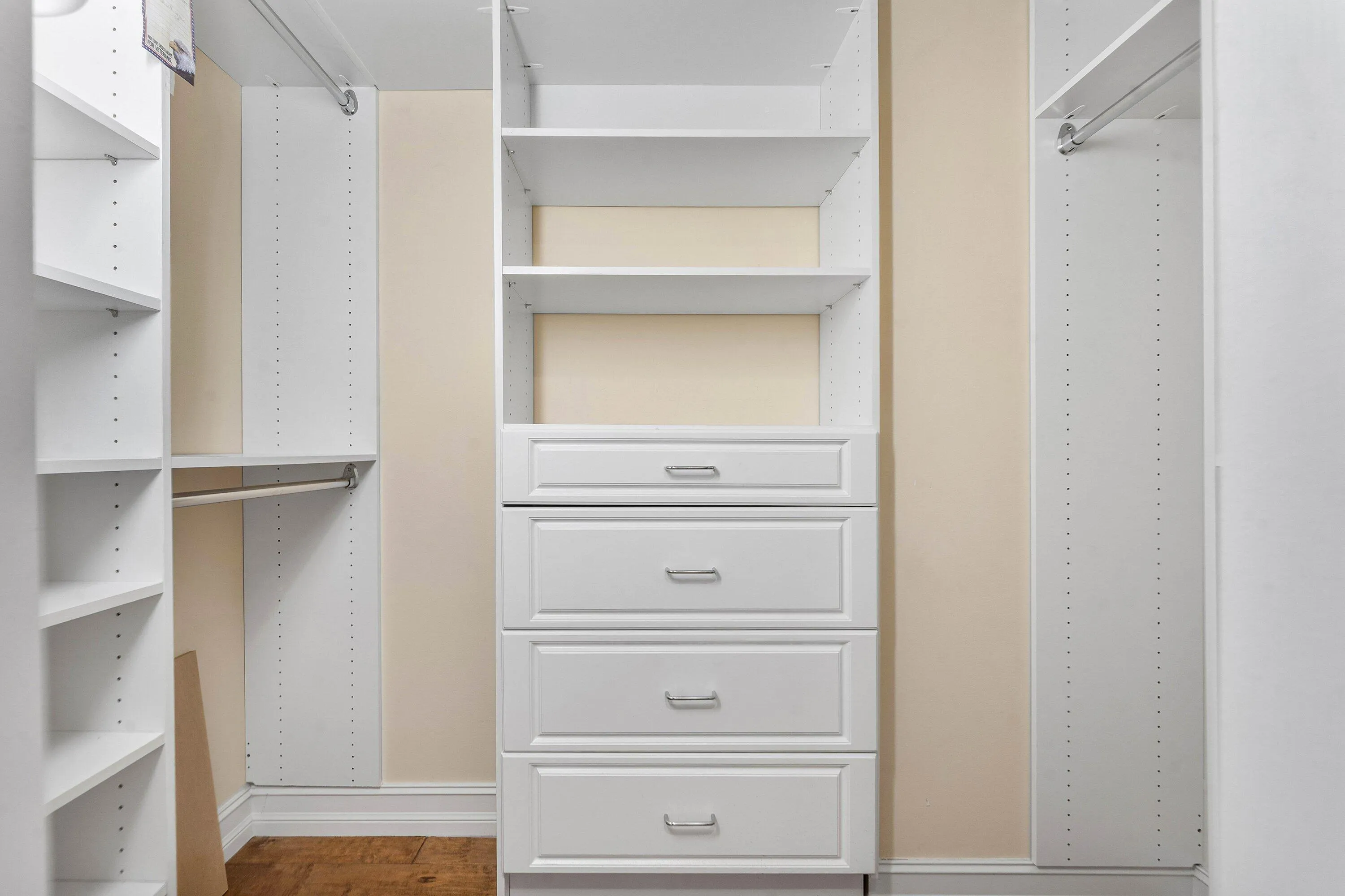 The walk-in closet provides extensive built-in shelving, hanging space and drawer storage.
