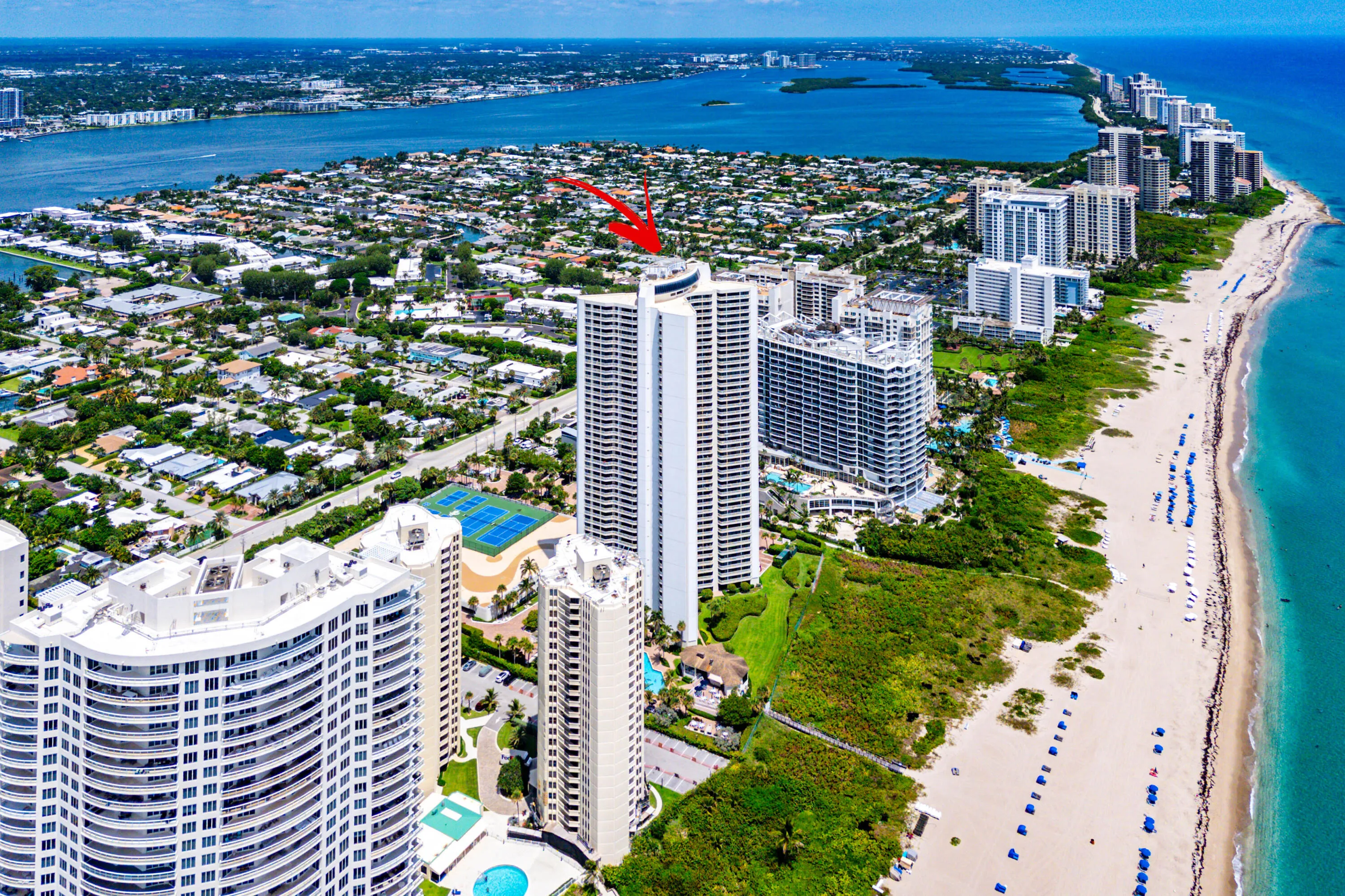 Virtually staged; residence is offered unfurnished. The primary bedroom frames direct Atlantic Ocean views and opens to the balcony.