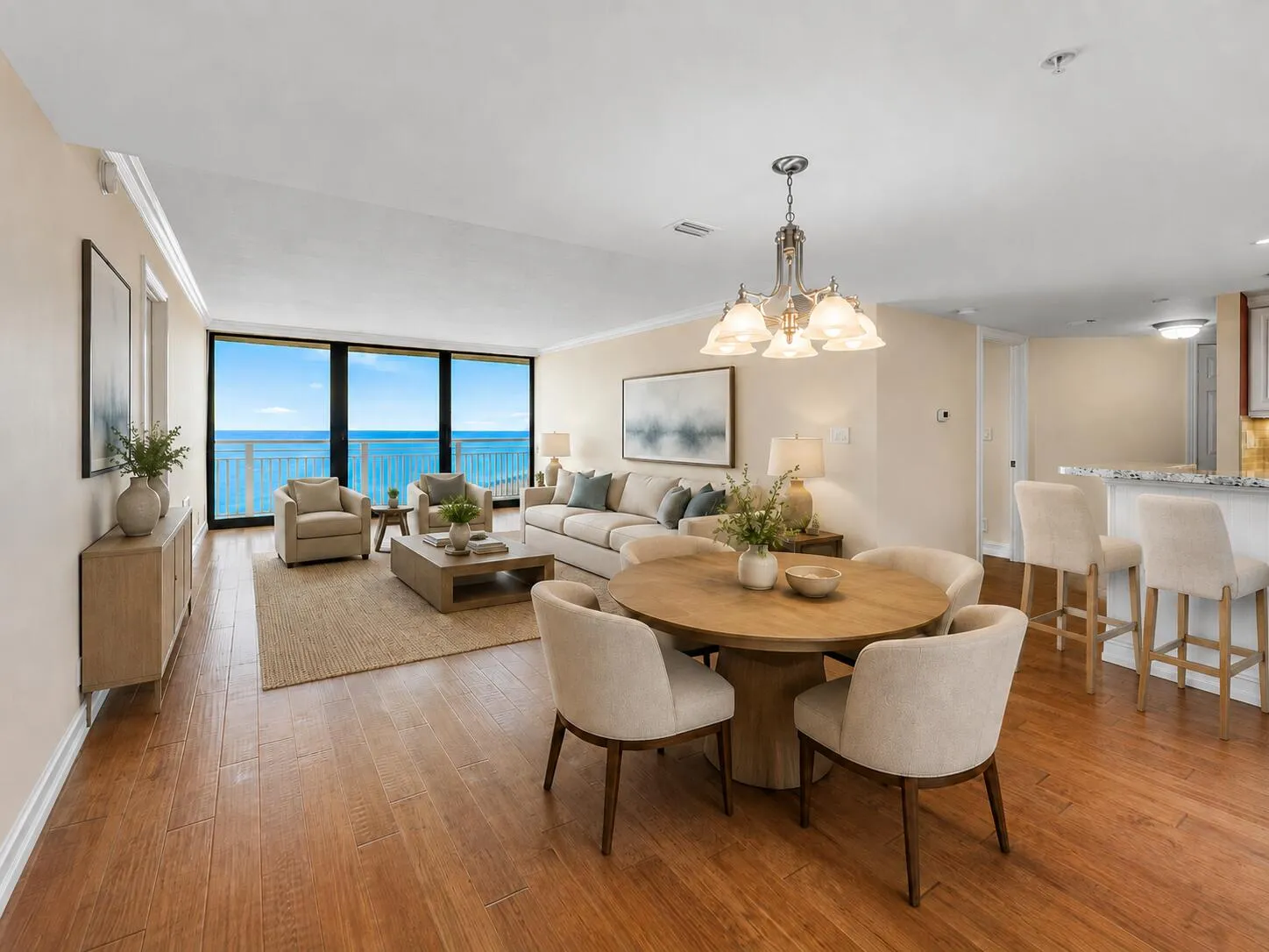 Virtually staged; residence is offered unfurnished. The open living and dining area is framed by direct Atlantic Ocean views, with the kitchen and breakfast bar creating an easy flow for everyday living and entertaining.