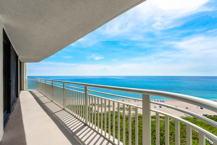 The covered oceanfront balcony opens to wide Atlantic Ocean and Singer Island beach views from this 15th-floor residence.