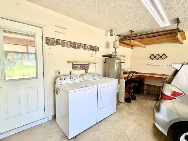 2 car garage with pedestrian door to lanai, access to attic, washer and dryer do convey.