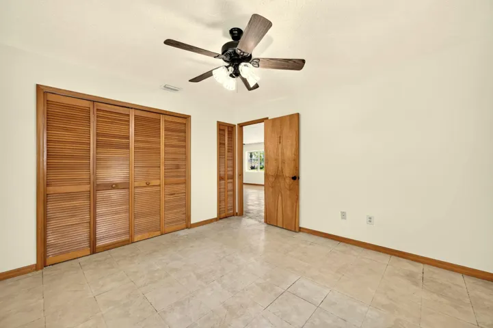 BEDROOM 2 faces back yard. Bathroom is adjacent and also serves as guest bathroom.