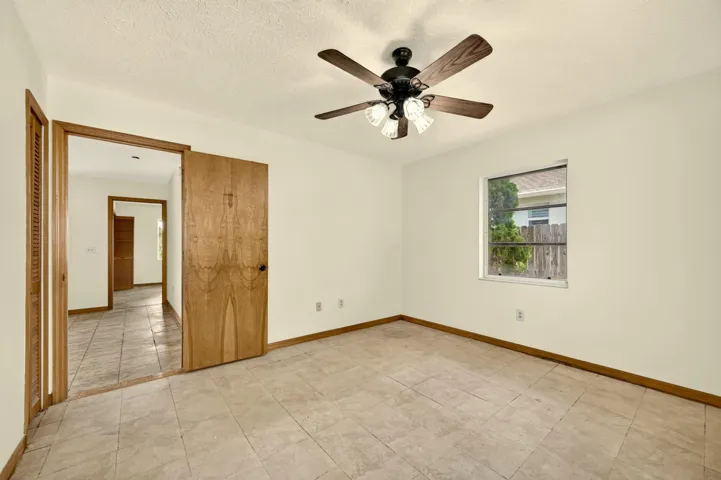 BEDROOM 2 faces back yard. Bathroom is adjacent and also serves as guest bathroom.