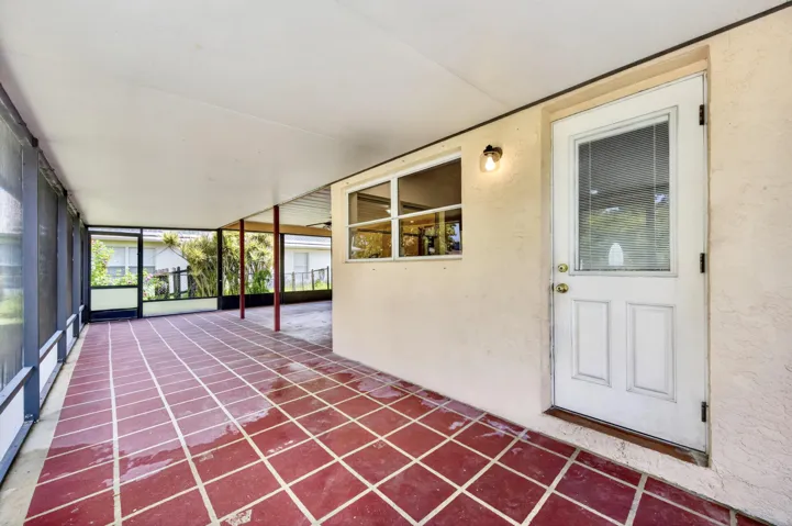 500+ SF of COVERED AND SCREENED LANAI with 2 pedestrian doors. Opens to Large fenced backyard.