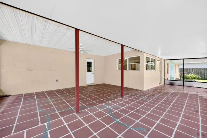 500+ SF of COVERED AND SCREENED LANAI with 2 pedestrian doors. Opens to Large fenced backyard.