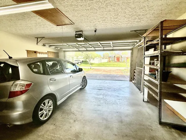 2 car garage with pedestrian door to lanai, access to attic, washer and dryer do convey.