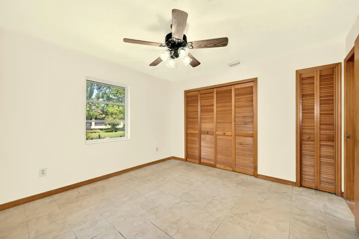 BEDROOM 2 faces back yard. Bathroom is adjacent and also serves as guest bathroom.