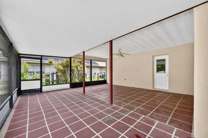 500+ SF of COVERED AND SCREENED LANAI with 2 pedestrian doors. Opens to Large fenced backyard.