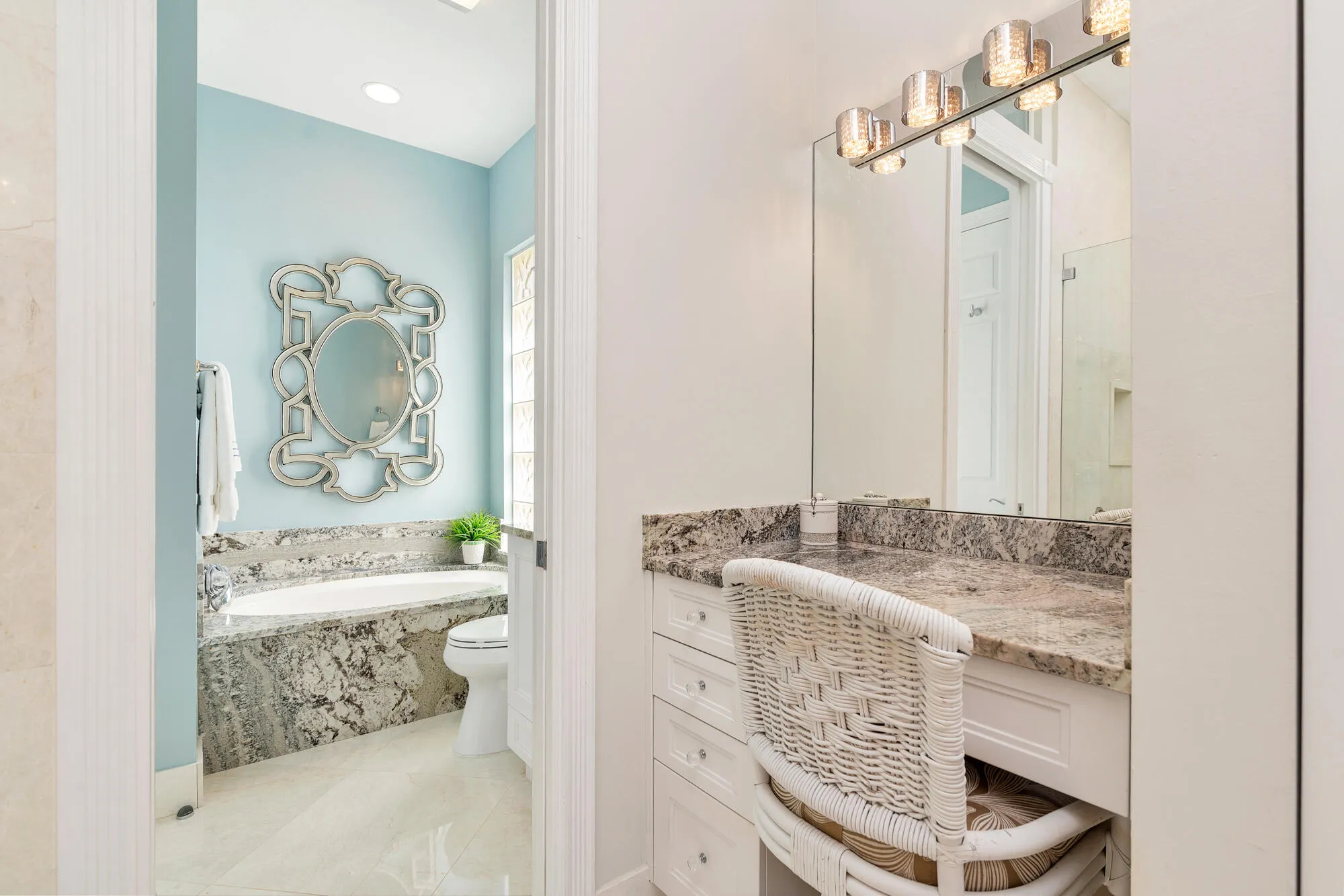 Primary bathroom with vanity, custom lighting & mirrors