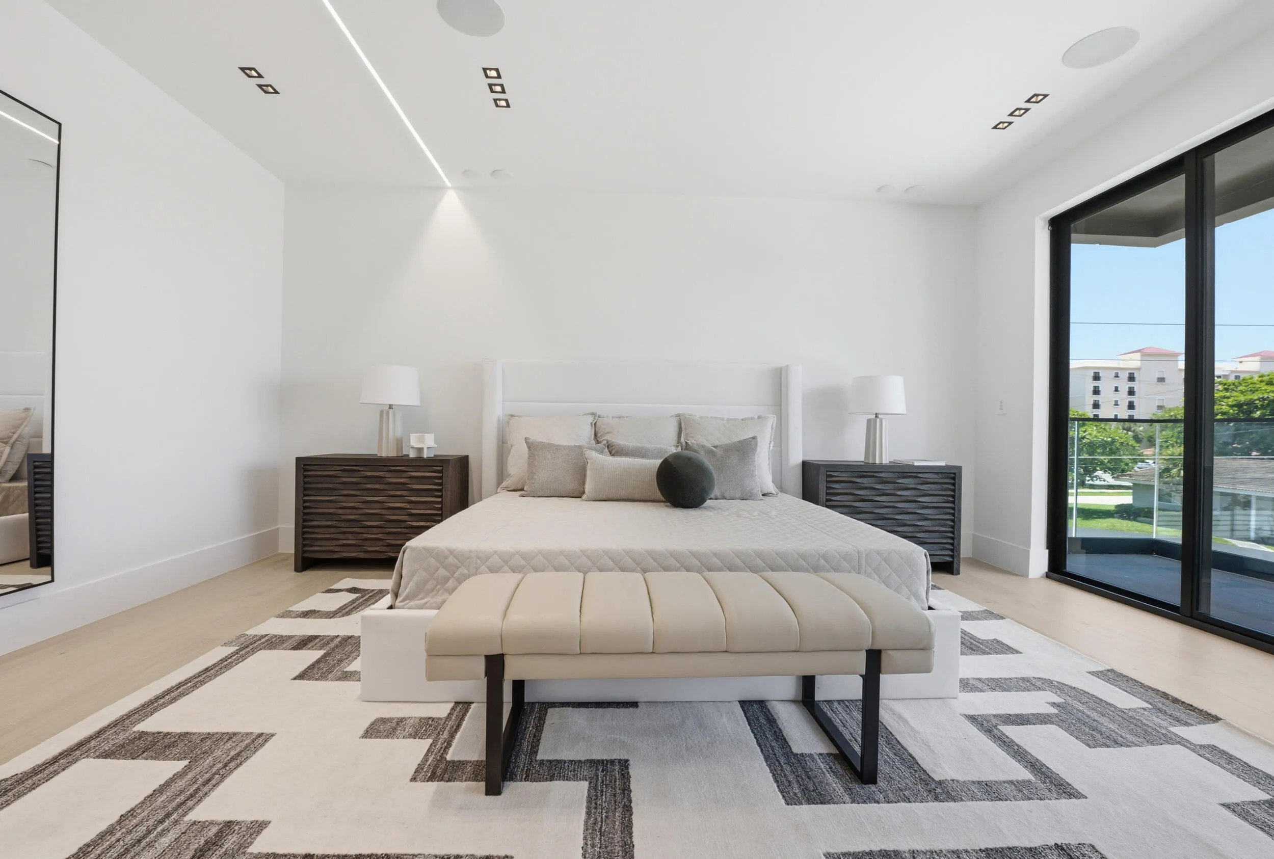 Hardwood-style flooring, expansive sliding glass doors, recessed lighting, and built-in ceiling speakers