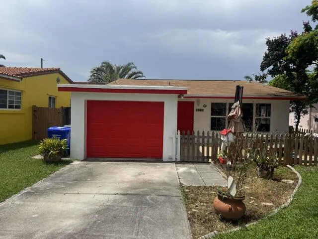 freshly painted house with large parking in front of hurricane impact door