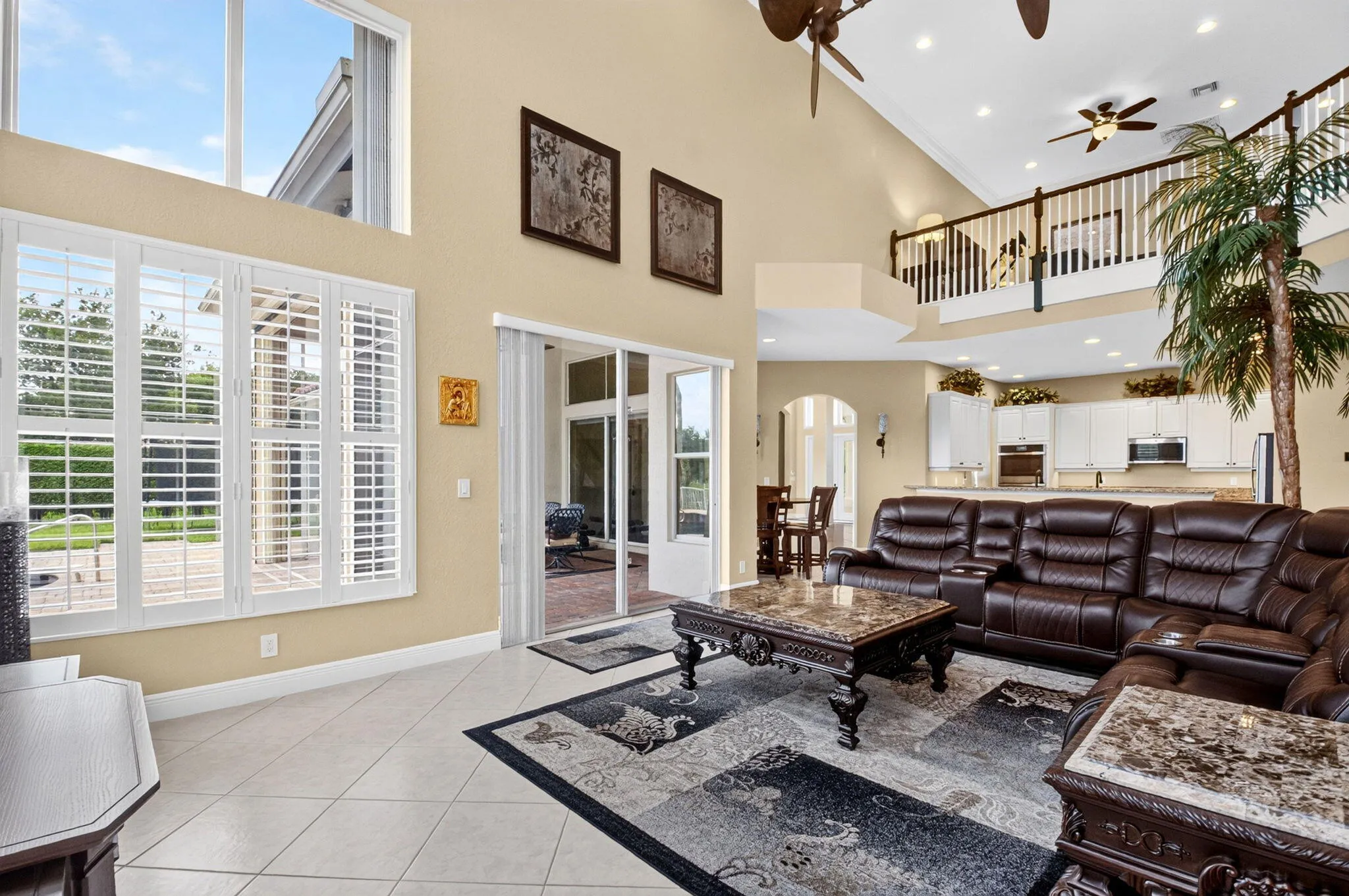 Vaulted ceilings with recessed lighting, tile flooring, and transom windows
