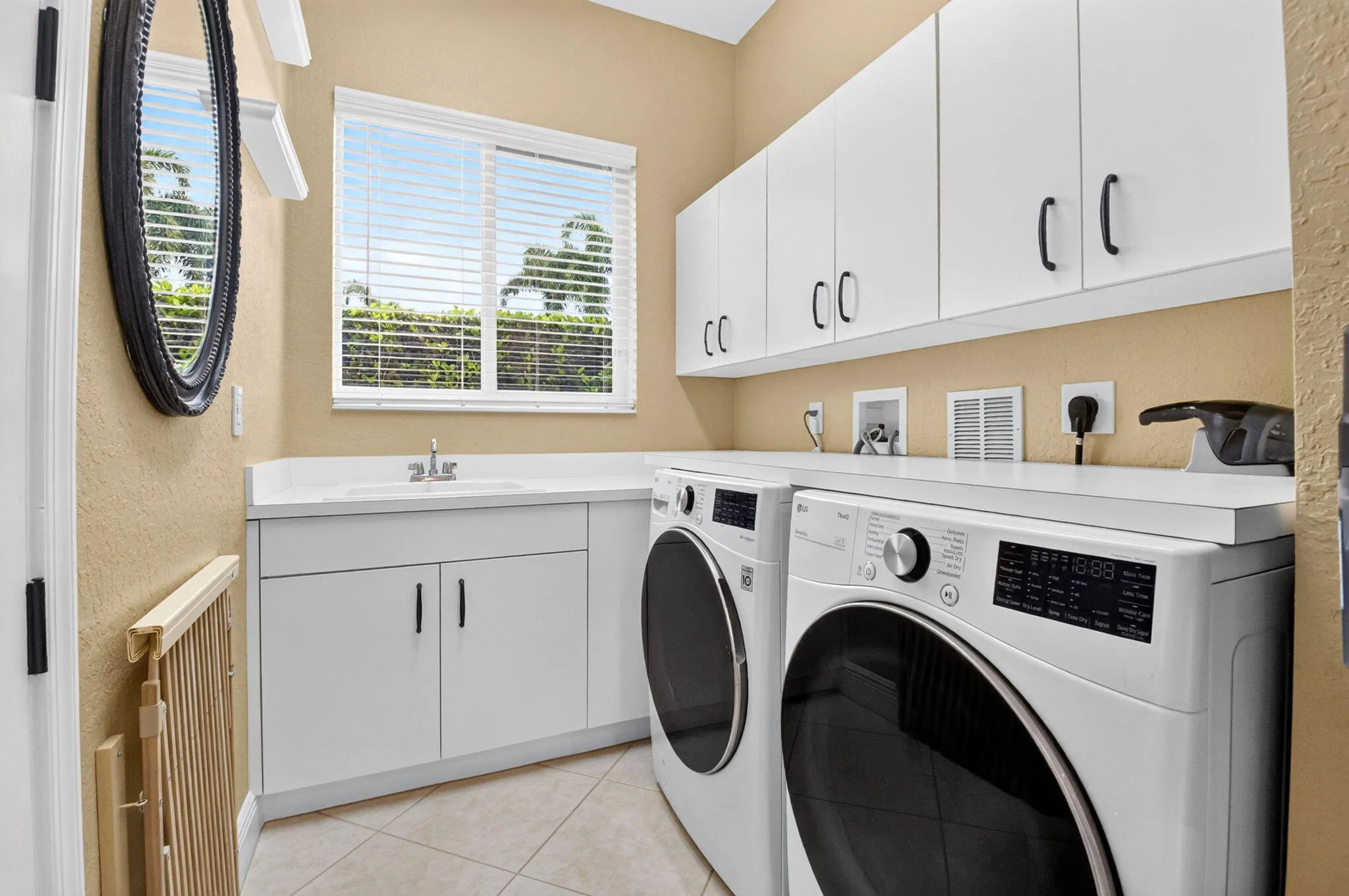 White cabinetry, integrated sink, and ample countertop space