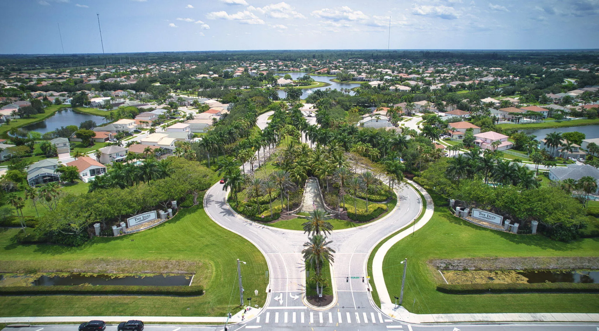 Lush green landscaping surrounding a residential community entrance