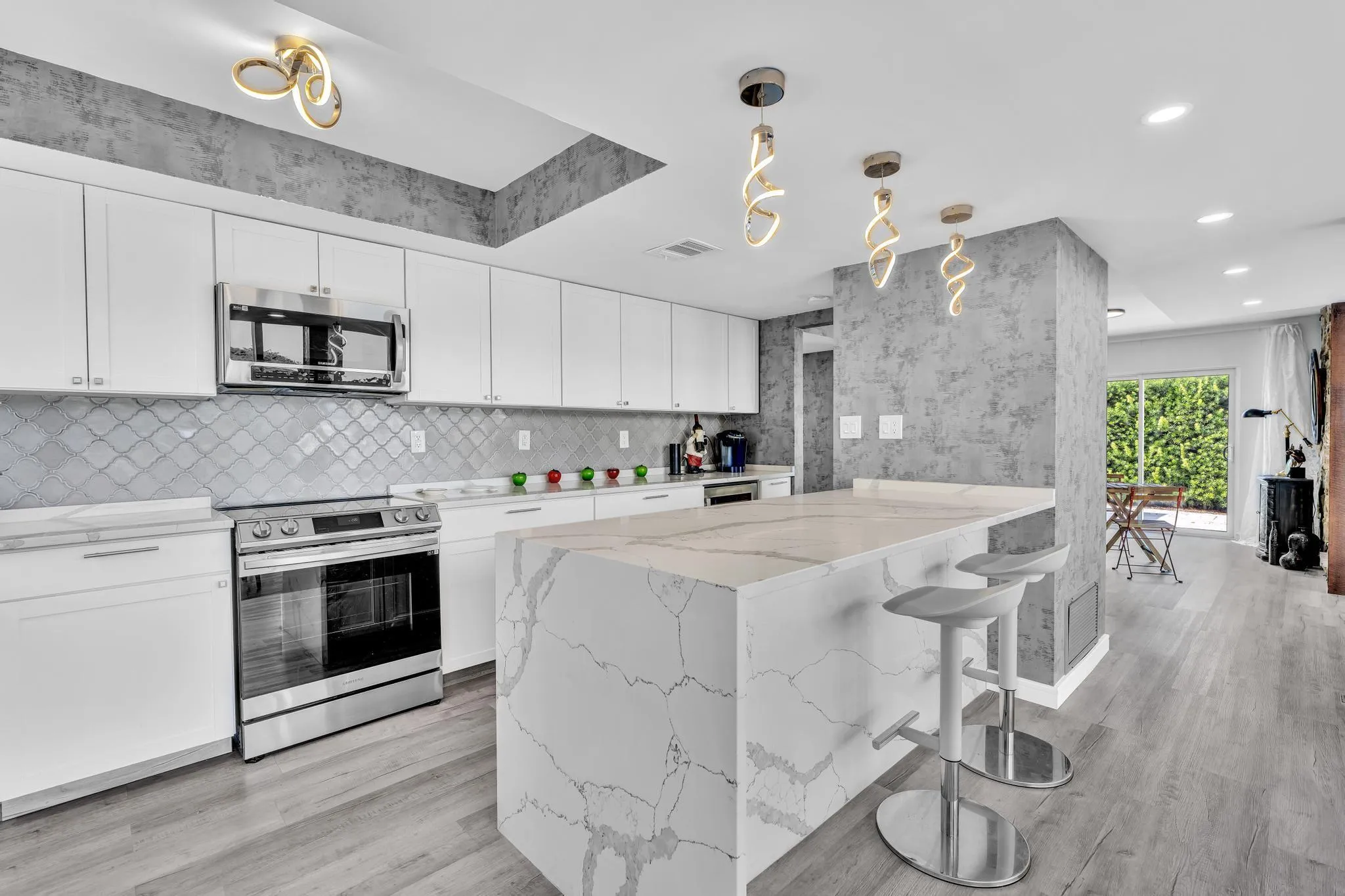 Open concept kitchen with marble counter tops and expansive counter space.