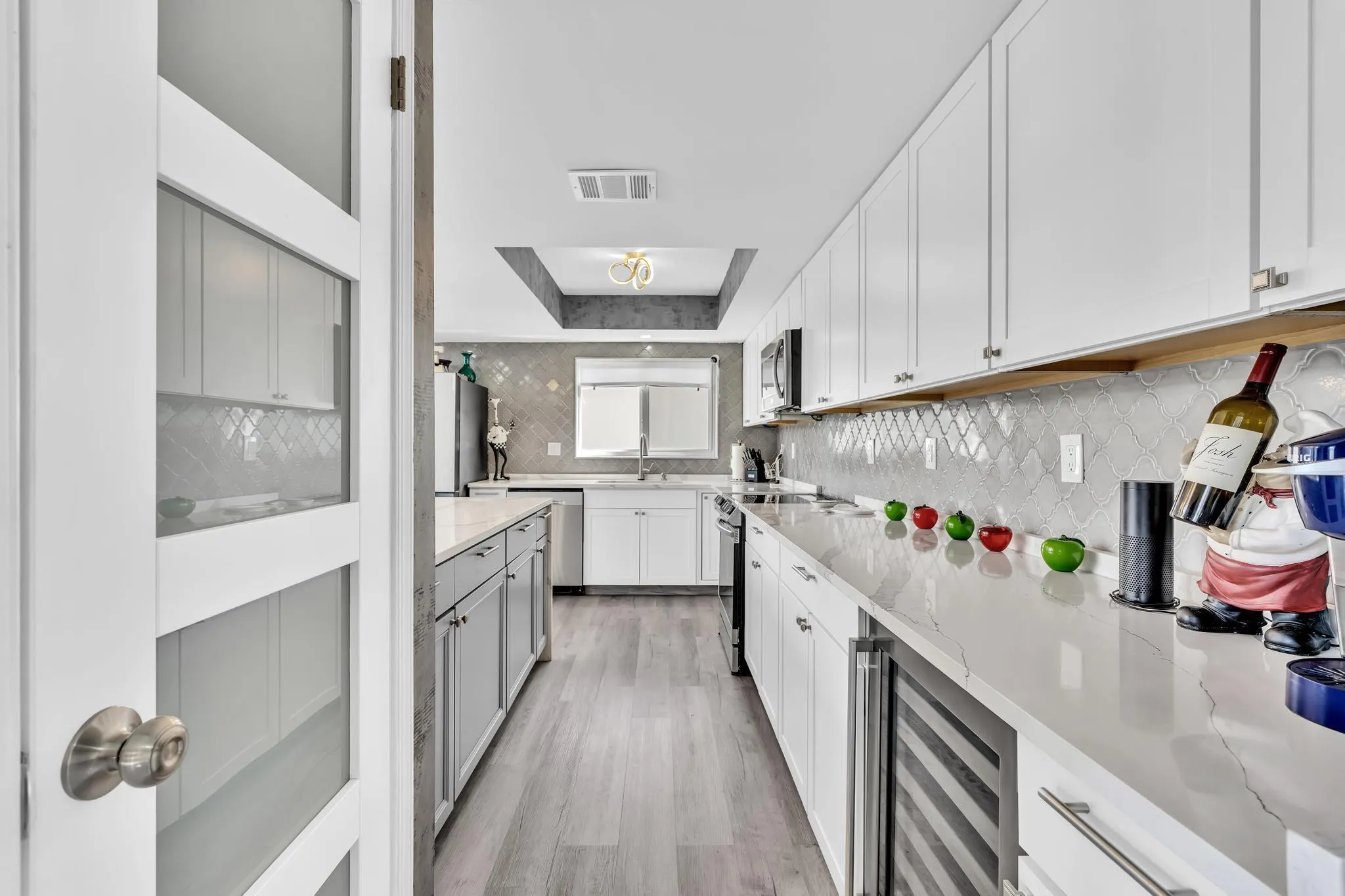 Kitchen Entryway with stainless steel appliances and wine fridge.